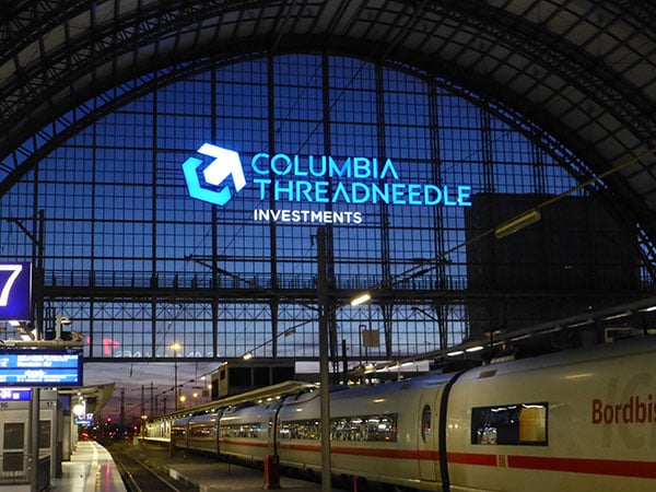 Frankfurt station with blue Columbia Threadneedle Investments sign